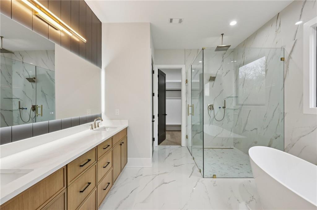 24 Rocking Wood Drive Auburn, GA 30011 - Photo 32 of 66 a spacious bathroom with a granite countertop sink mirror and shower
