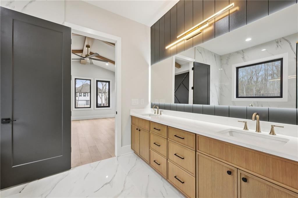 24 Rocking Wood Drive Auburn, GA 30011 - Photo 33 of 66 a spacious bathroom with double vanity a mirror a vanity and a shower