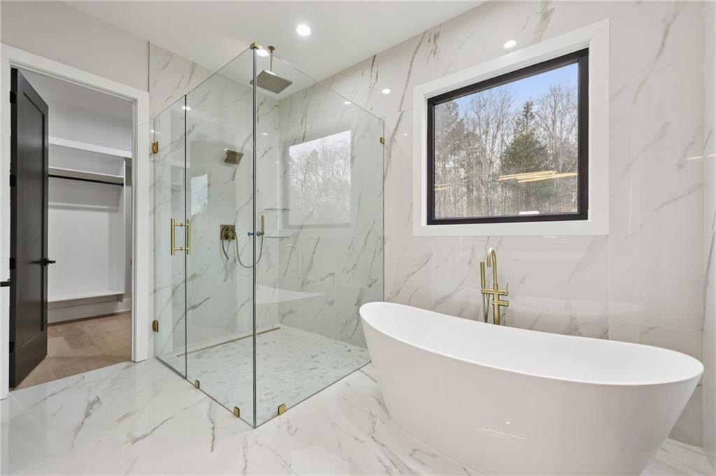 24 Rocking Wood Drive Auburn, GA 30011 - Photo 34 of 66 a white bath tub sitting next to a bathroom