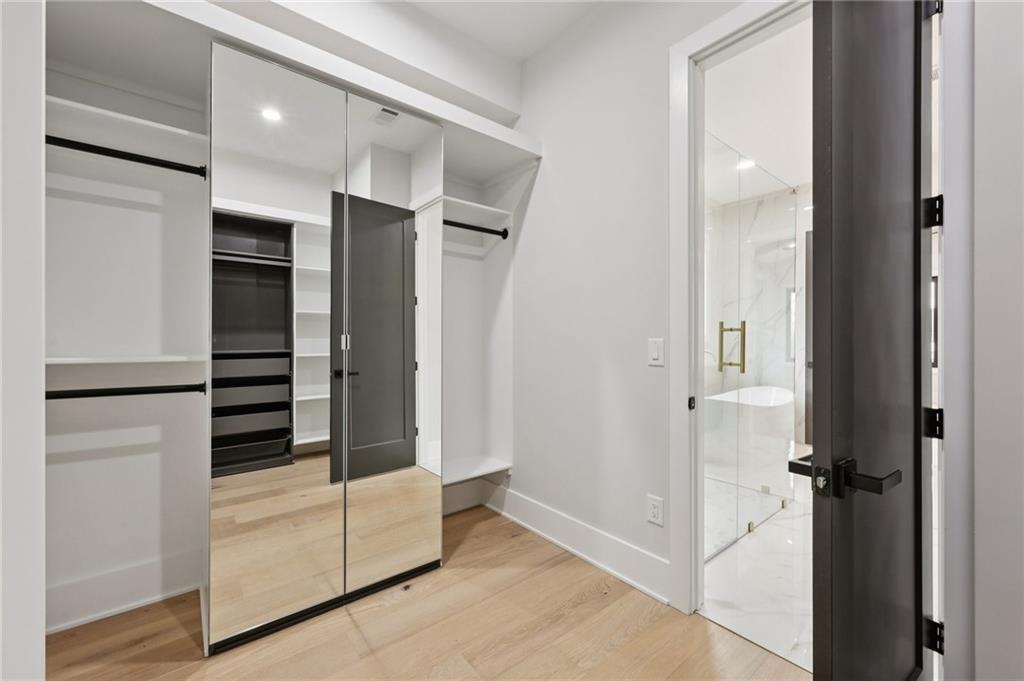 24 Rocking Wood Drive Auburn, GA 30011 - Photo 36 of 66 an entryway at the kitchen and an empty room with wooden floor