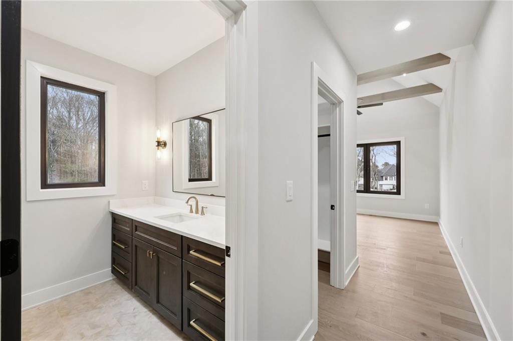 24 Rocking Wood Drive Auburn, GA 30011 - Photo 44 of 66 a spacious bathroom with a mirror sink and vanity