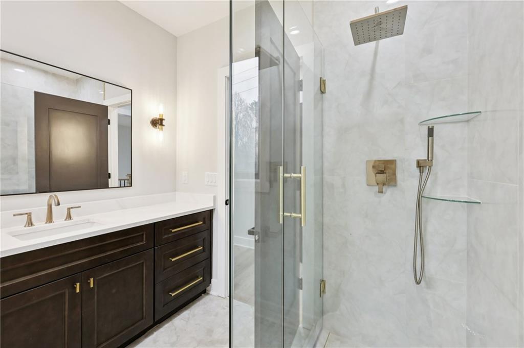 24 Rocking Wood Drive Auburn, GA 30011 - Photo 45 of 66 a bathroom with a double vanity sink mirror and shower