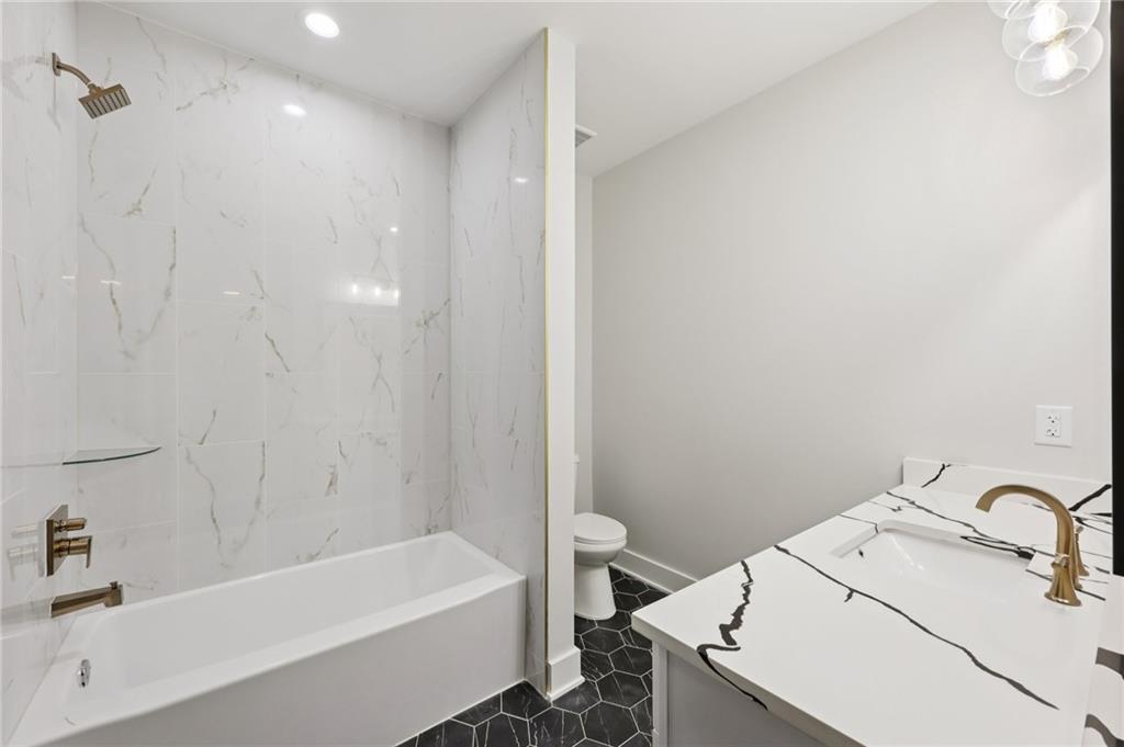 24 Rocking Wood Drive Auburn, GA 30011 - Photo 49 of 66 a bathroom with a sink and a bathtub