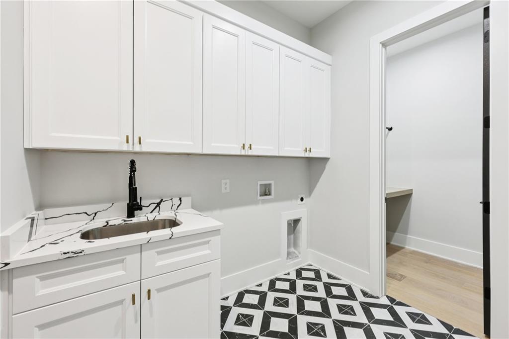 24 Rocking Wood Drive Auburn, GA 30011 - Photo 54 of 66 a kitchen with a sink and cabinets