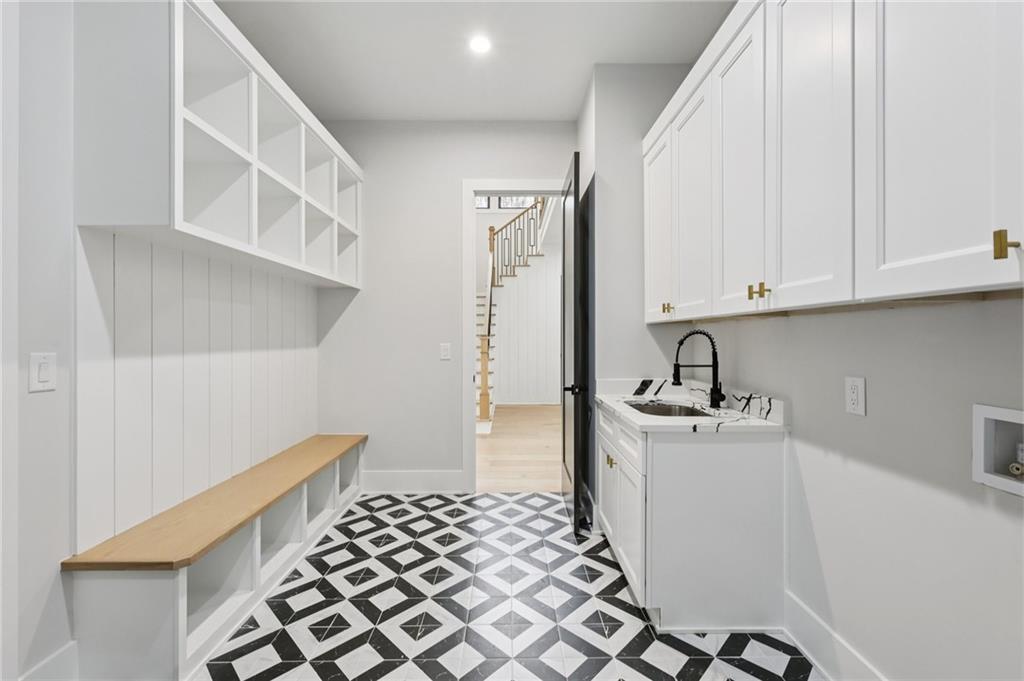 24 Rocking Wood Drive Auburn, GA 30011 - Photo 55 of 66 a kitchen with a sink a stove and white cabinets