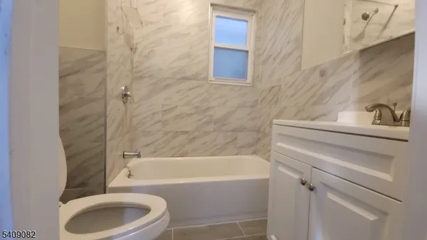 a bathroom with a toilet and a bathtub