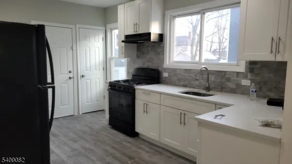 a kitchen with a refrigerator and a sink