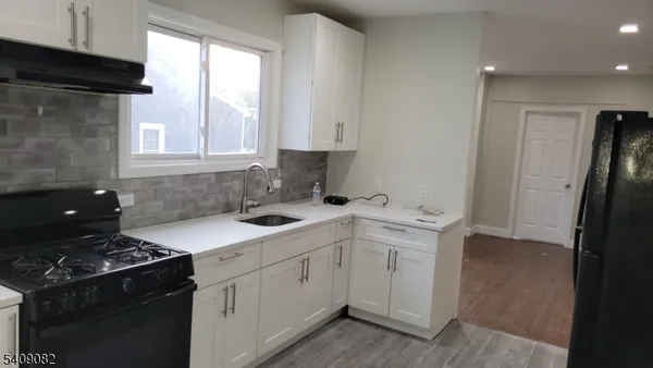 a kitchen with a sink stove and refrigerator