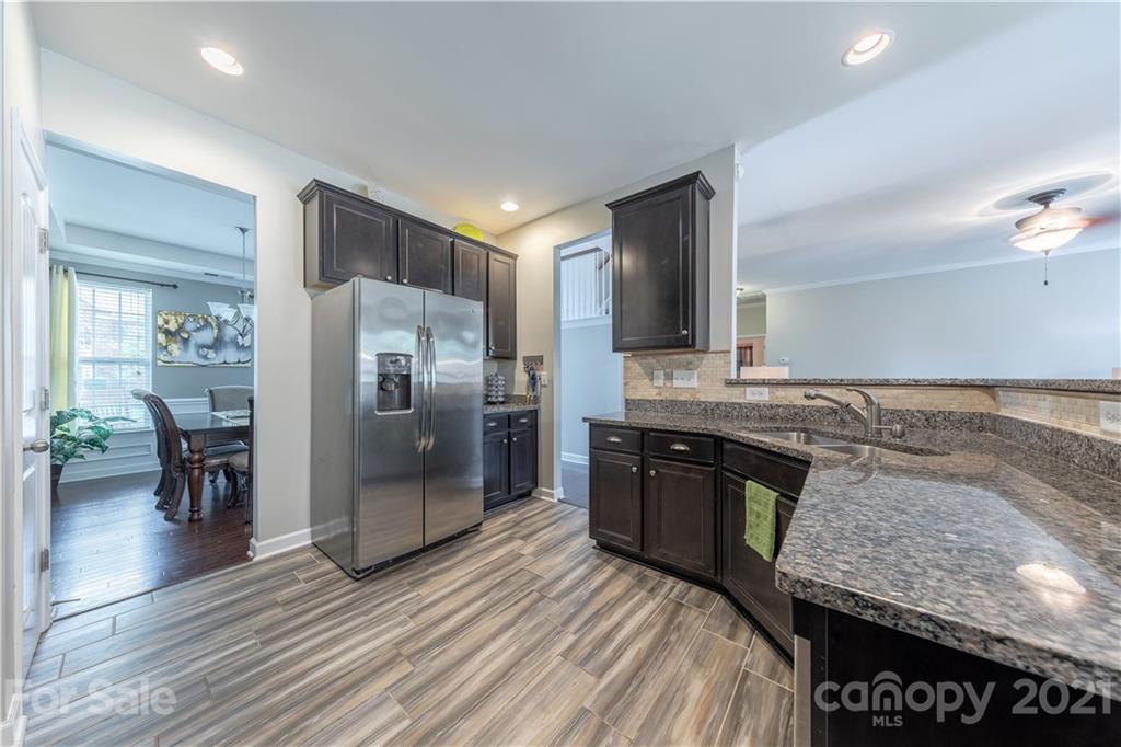 364 Lorraine Road Fort Mill, SC 29708 - Photo 15 of 39 a large kitchen with stainless steel appliances granite countertop a refrigerator a stove and a sink