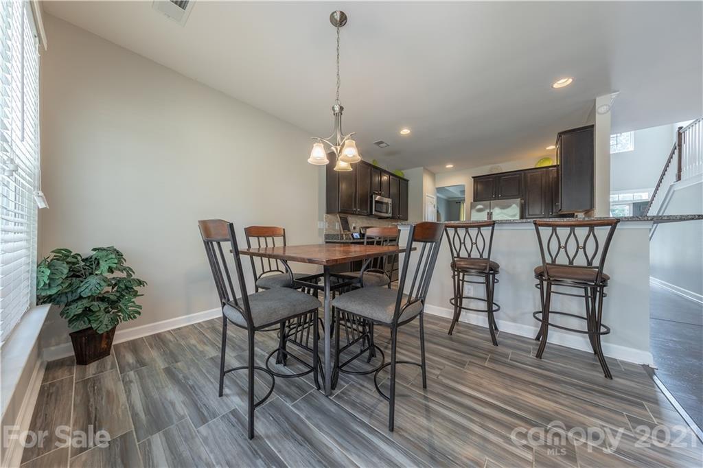 364 Lorraine Road Fort Mill, SC 29708 - Photo 17 of 39 a view of a dining room with furniture and wooden floor