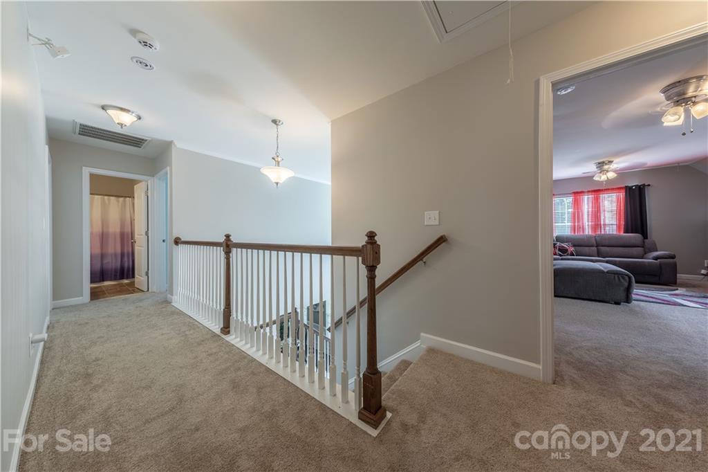 364 Lorraine Road Fort Mill, SC 29708 - Photo 21 of 39 a view of a hallway with a livingroom and a chandelier fan