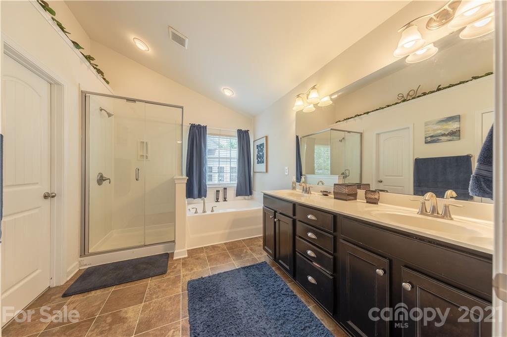 364 Lorraine Road Fort Mill, SC 29708 - Photo 25 of 39 a spacious bathroom with a double vanity sink a large mirror and a shower