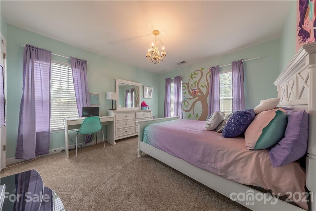 364 Lorraine Road Fort Mill, SC 29708 - Photo 27 of 39 a bedroom with a bed and a chandelier