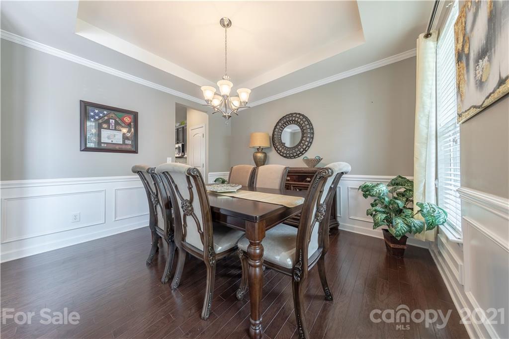 364 Lorraine Road Fort Mill, SC 29708 - Photo 8 of 39 a dining room with furniture a chandelier and wooden floor