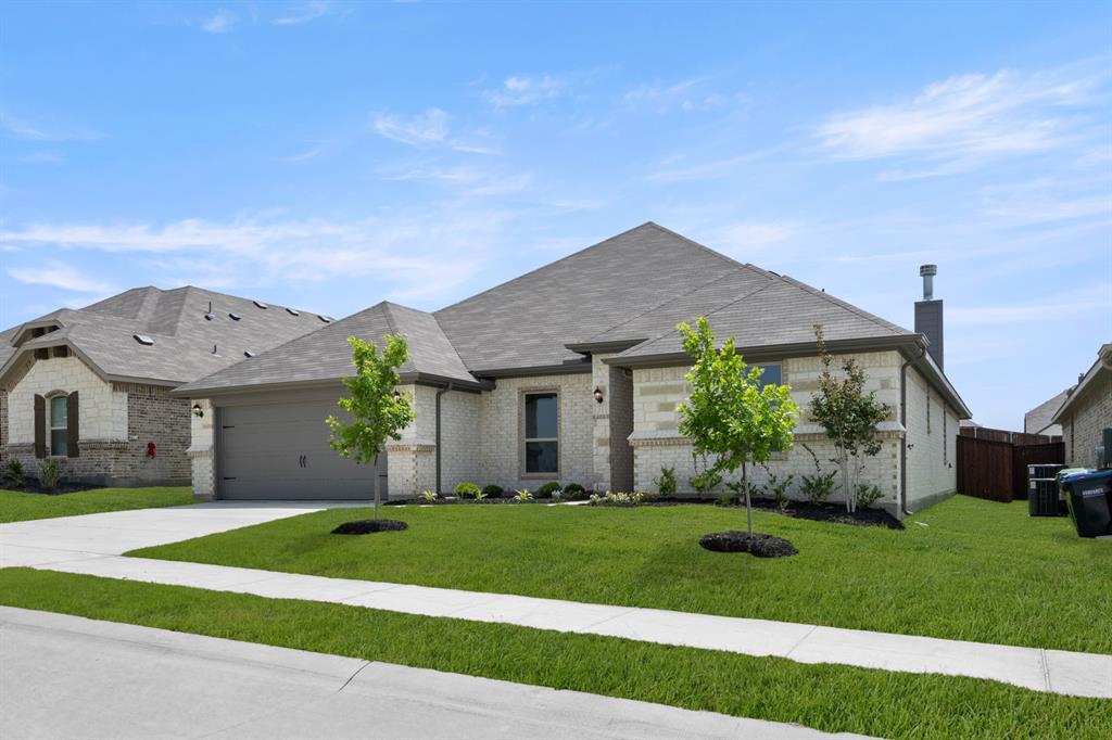 228 Shepards Street Godley, TX 76044 - Photo 2 of 27 a front view of a house with a yard and garage