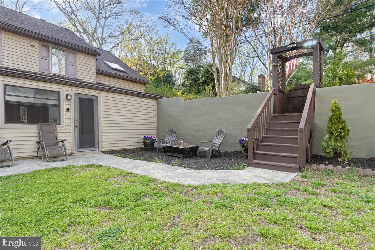 425 Mountain Road Crownsville, MD 21032 - Photo 12 of 69 a view of a backyard with chairs and a fire pit