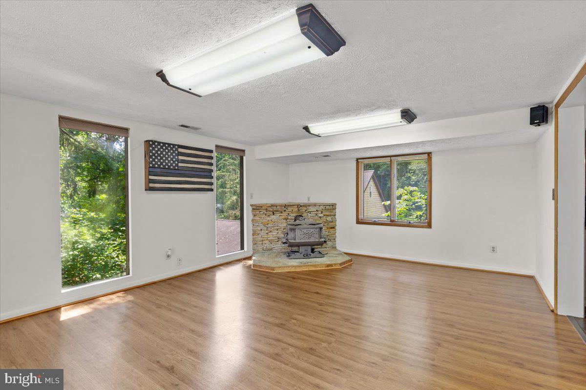 425 Mountain Road Crownsville, MD 21032 - Photo 22 of 69 a view of an empty room with a window and wooden floor