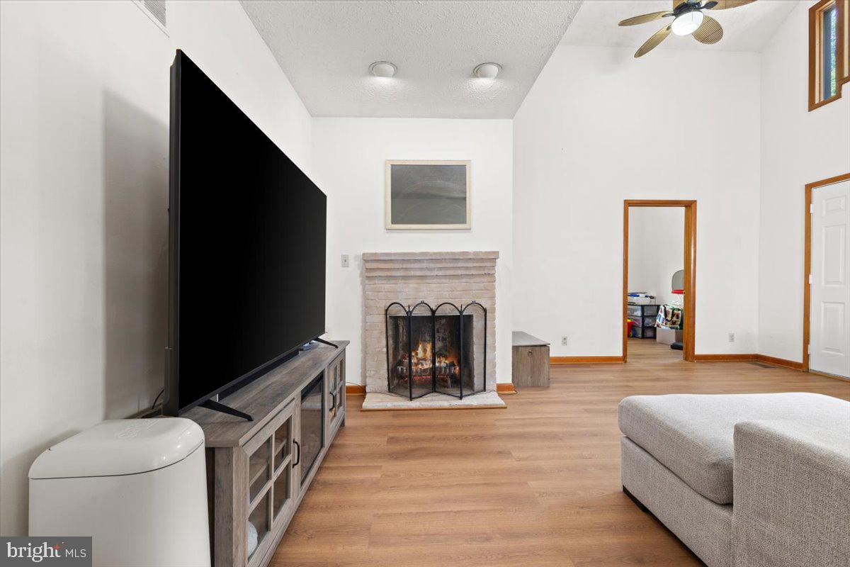 425 Mountain Road Crownsville, MD 21032 - Photo 31 of 69 a living room with furniture a flat screen tv and a fireplace