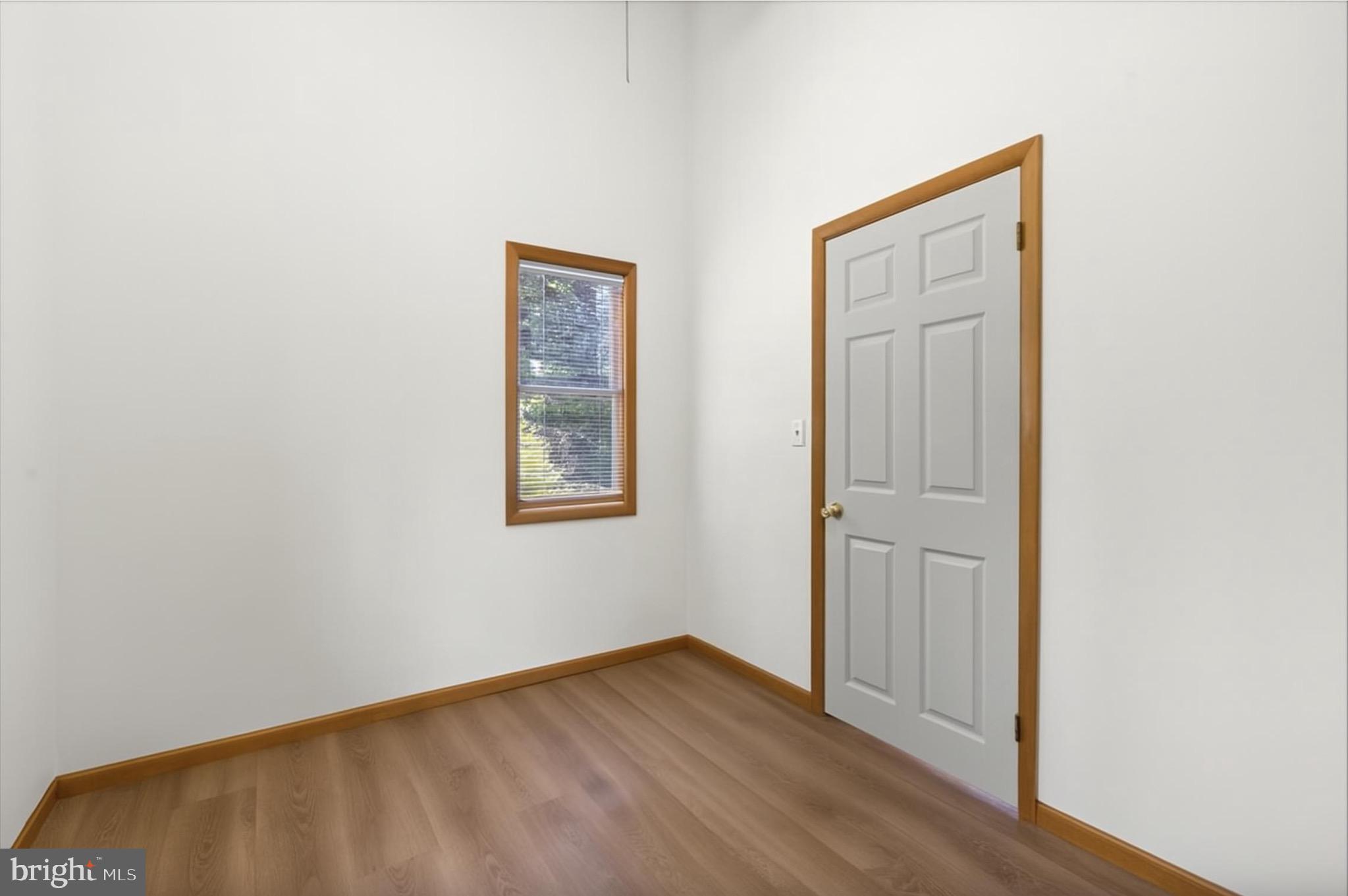 425 Mountain Road Crownsville, MD 21032 - Photo 32 of 69 a view of an empty room with wooden floor and a window