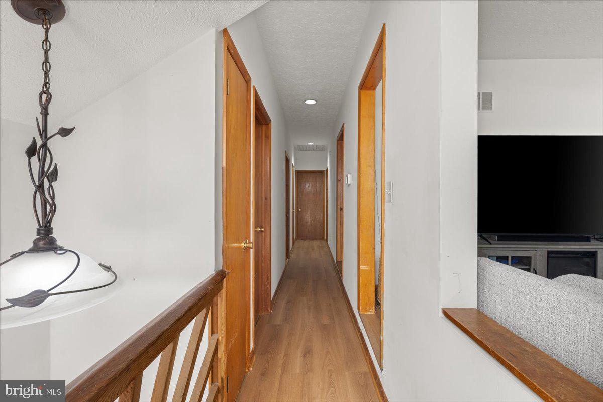 425 Mountain Road Crownsville, MD 21032 - Photo 34 of 69 a view of a hallway with wooden floor and furniture