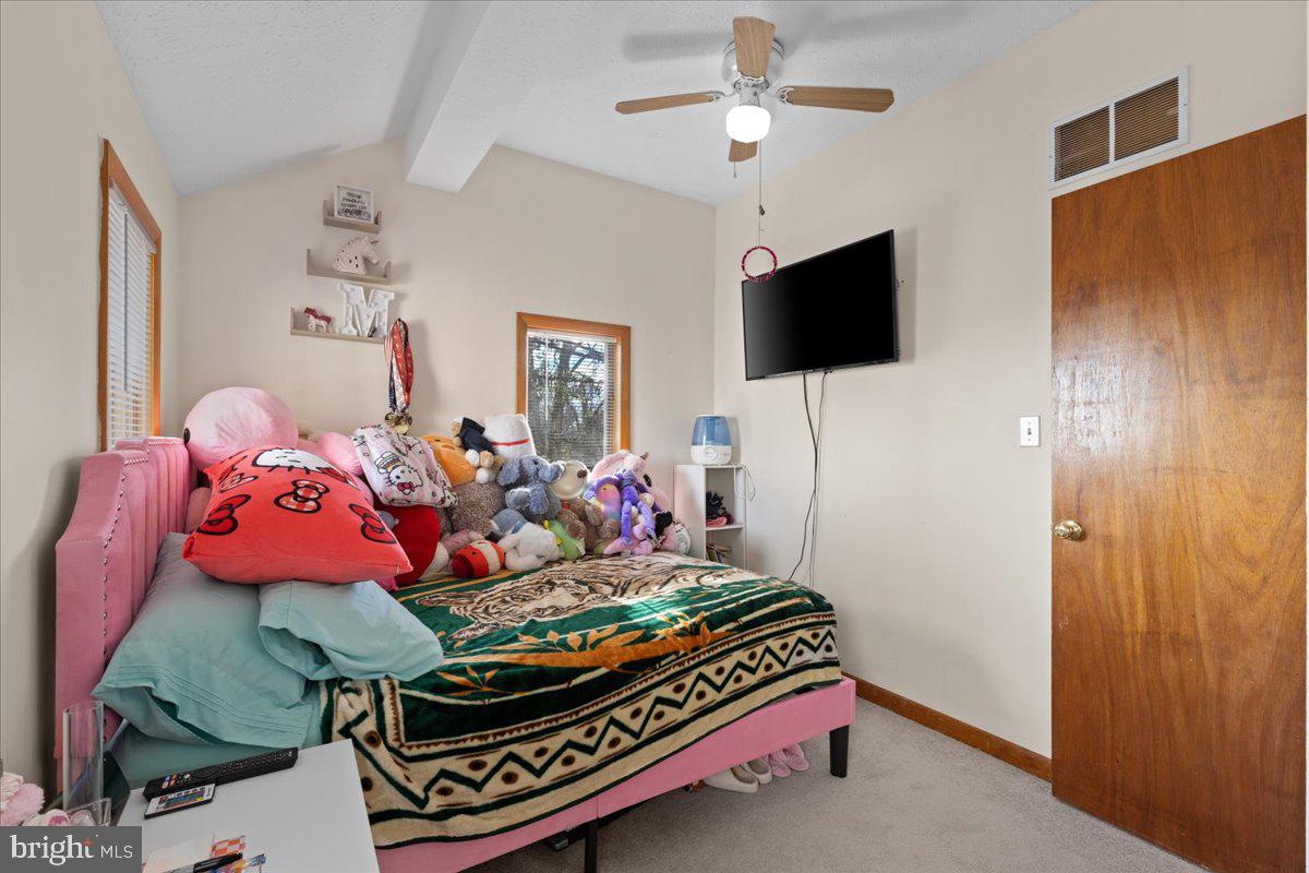 425 Mountain Road Crownsville, MD 21032 - Photo 39 of 69 a bedroom with a bed and a flat screen tv