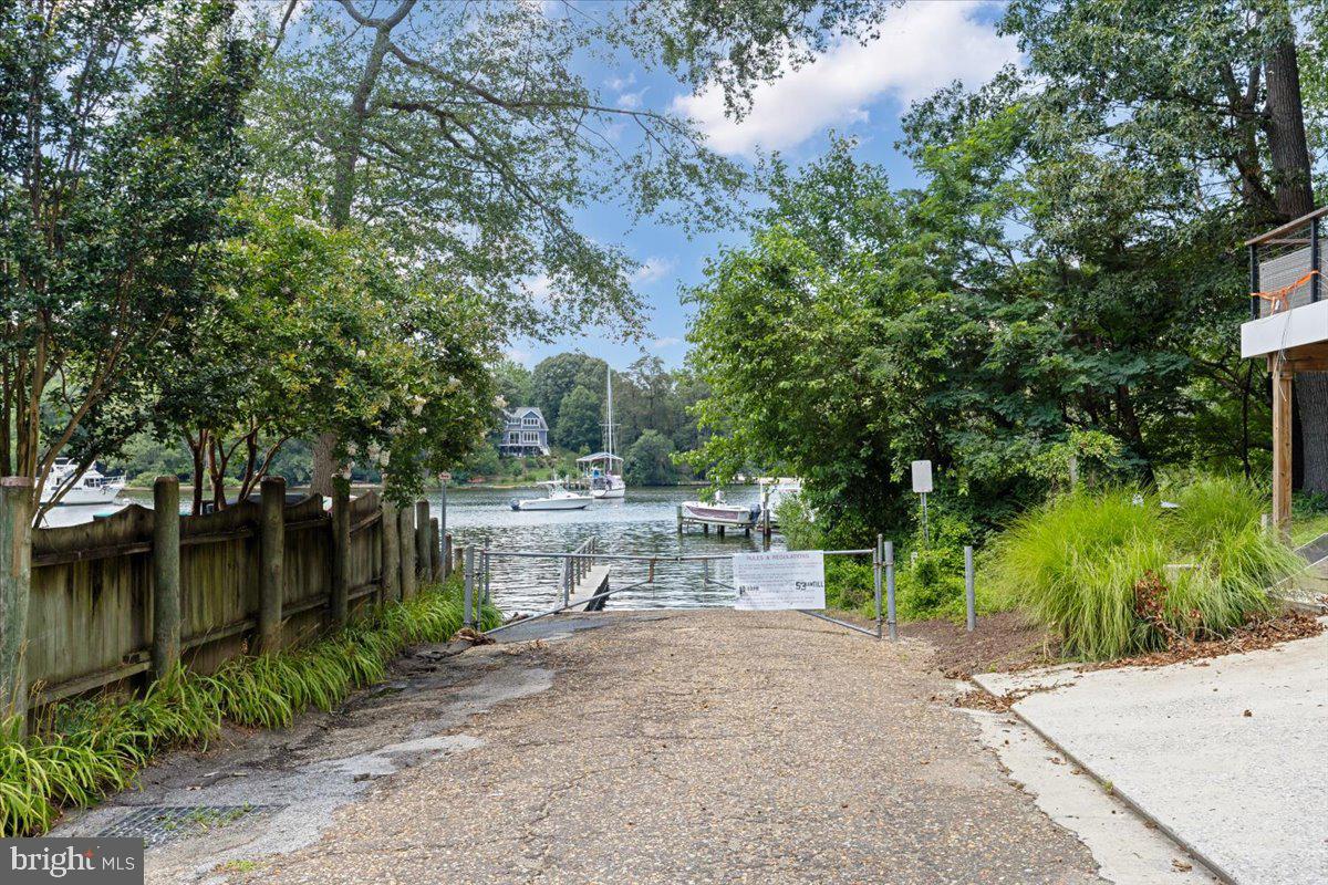 425 Mountain Road Crownsville, MD 21032 - Photo 67 of 69 a view of a yard with plants and a bench under large trees