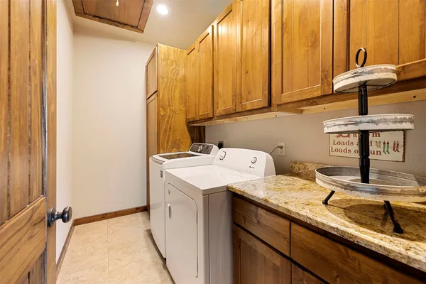 a storage room with a sink and cabinets
