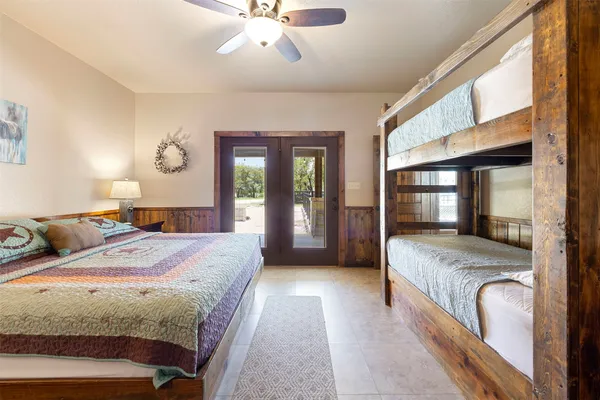 a bedroom with a large bed and a chandelier