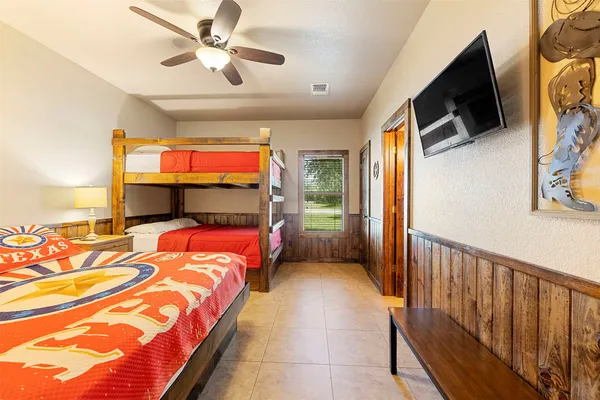 a bedroom with a bed and a flat screen tv