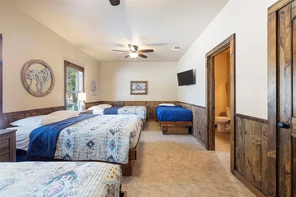 a bathroom with a granite countertop sink a toilet and a mirror