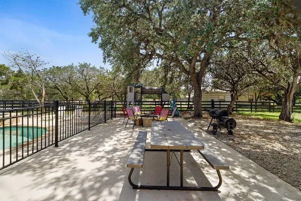 a view of a park with a bench and trees