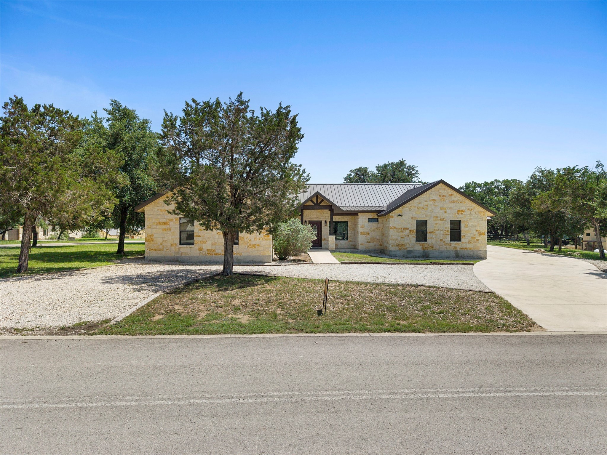 43 Heartstone Road Concan, TX 78838 - Photo 5 of 50 a front view of a house with a yard