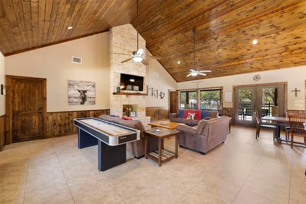 a living room with furniture a flat screen tv and a table