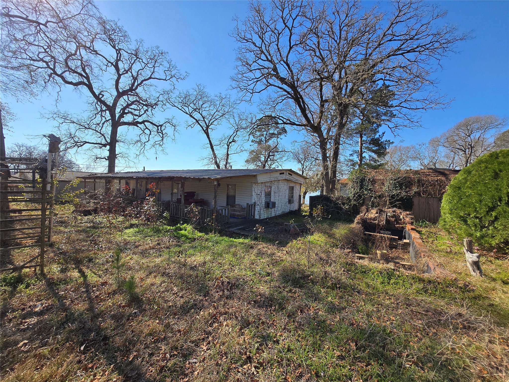 1188 Sportsman Drive Trinity, TX 75862 - Photo 15 of 26 a backyard of a house with table and chairs