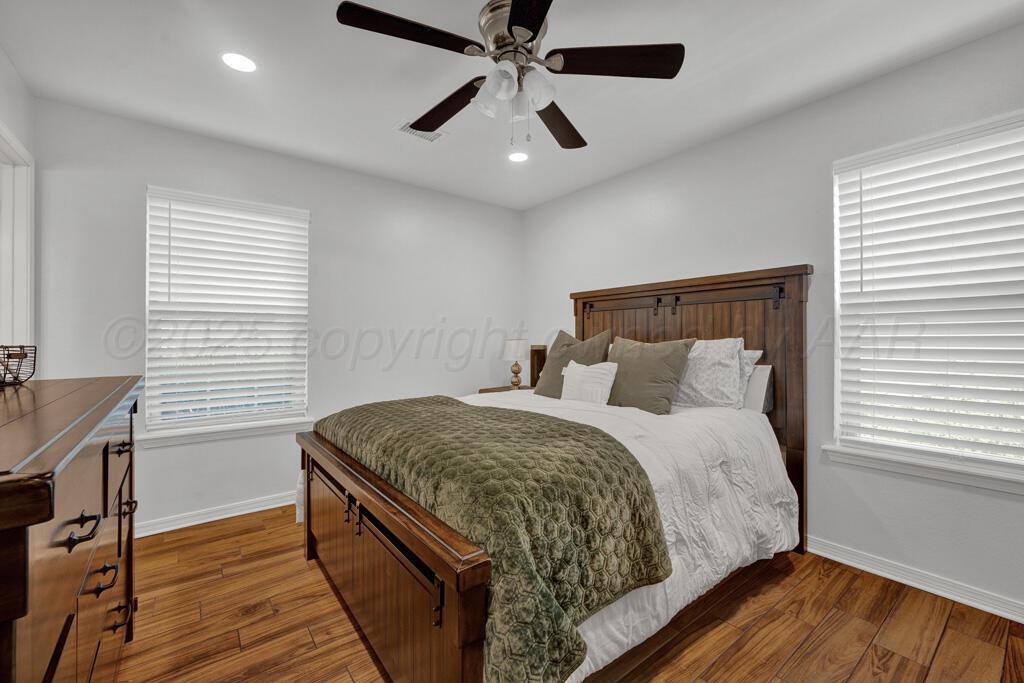 2405 Southwest 49th Avenue Amarillo, TX 79110 - Photo 17 of 25 a bedroom with a bed and wooden floor