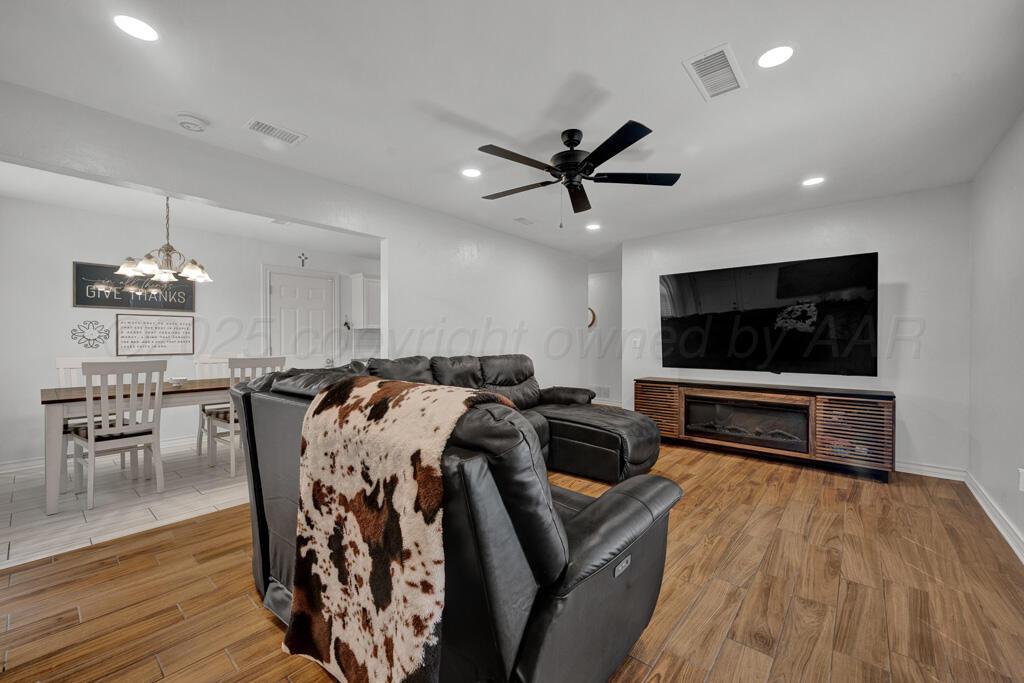 2405 Southwest 49th Avenue Amarillo, TX 79110 - Photo 4 of 25 a living room with furniture and a flat screen tv
