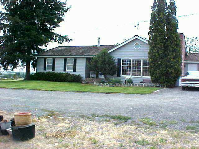 10812 Summitview Ext Road Yakima, WA 98908 - Photo 1 of 9 a front view of a house with a garden and trees