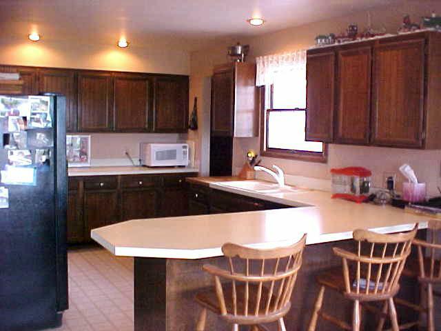 10812 Summitview Ext Road Yakima, WA 98908 - Photo 5 of 9 a kitchen with stainless steel appliances wooden floor dining table and chairs