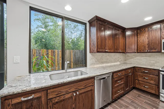 a kitchen with a sink window and cabinets