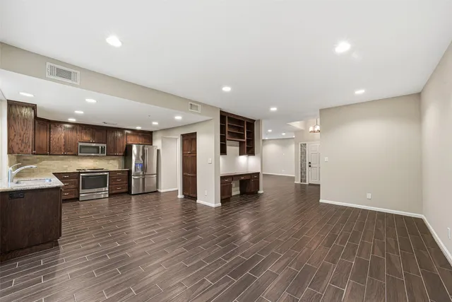 a view of kitchen with stainless steel appliances refrigerator and microwave