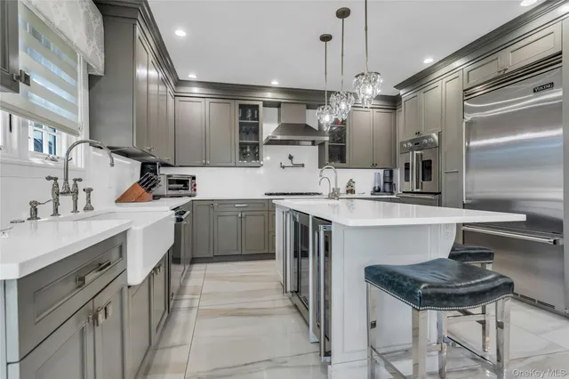 a kitchen with a dining table chairs stainless steel appliances and cabinets
