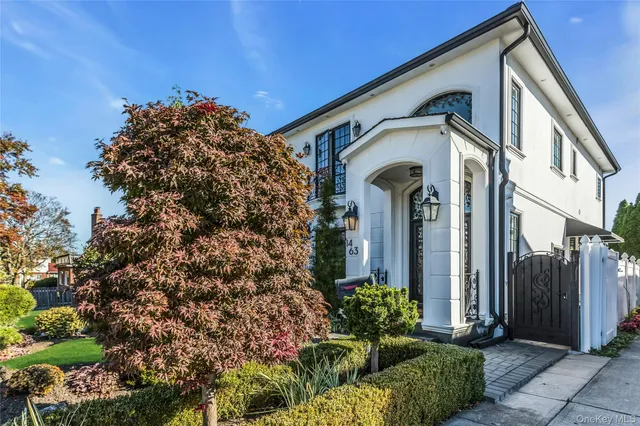 a front view of a house with a garden