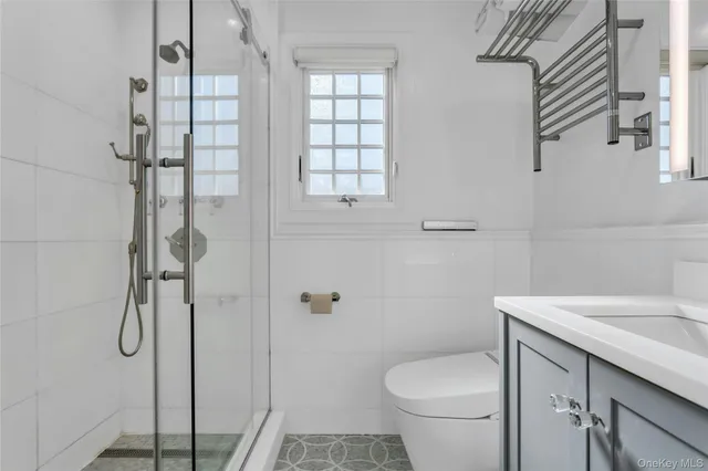 a bedroom with a large bed and a potted plant