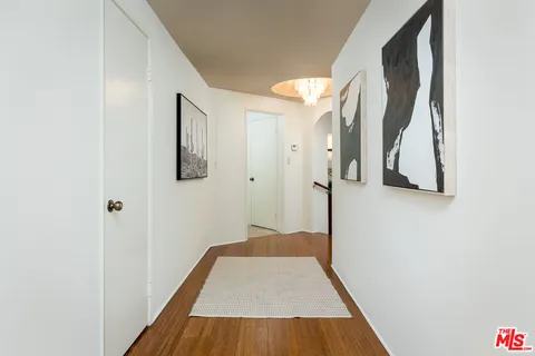 a view of hallway with wooden floor