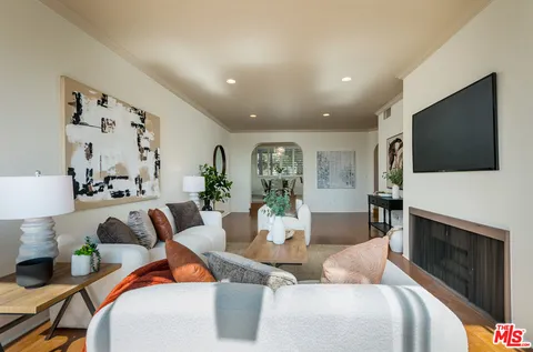 a living room with fireplace furniture and a flat screen tv