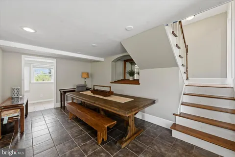 a living room with furniture a flat screen tv and a table