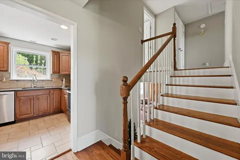 a view of entryway with wooden floor and cabinets