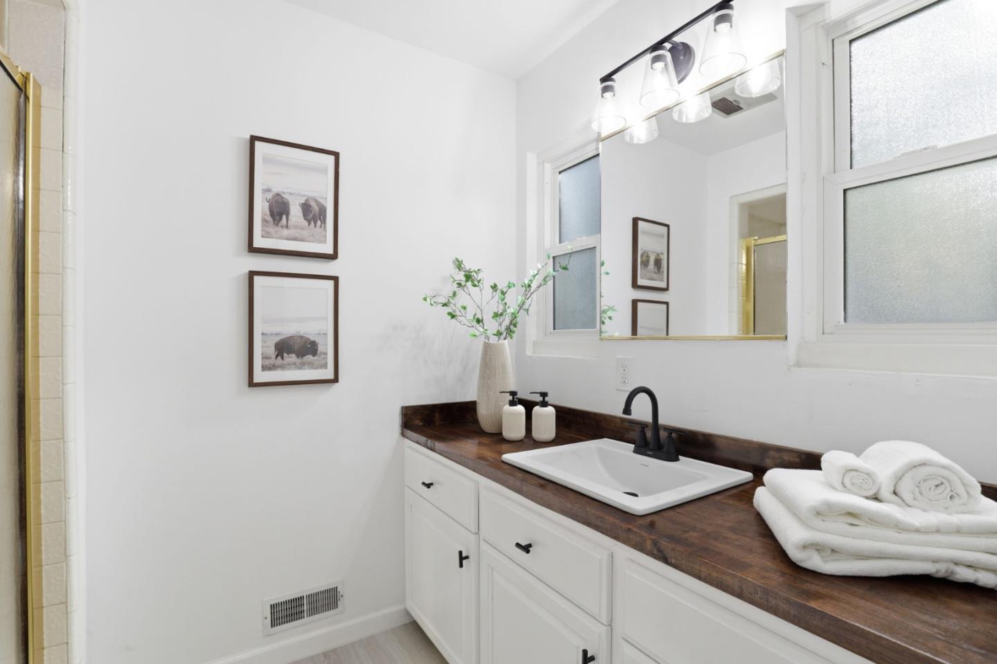 425 Summit Spring Road Woodside, CA 94062 - Photo 26 of 42 a bathroom with a granite countertop sink and a mirror