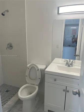 a bathroom with a sink toilet and vanity