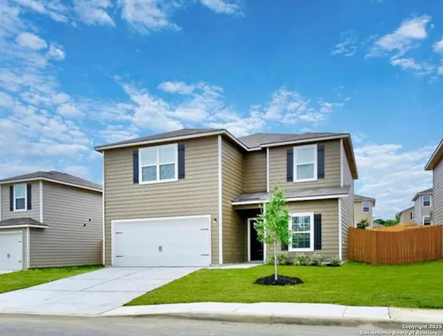 a front view of a house with a garden and yard